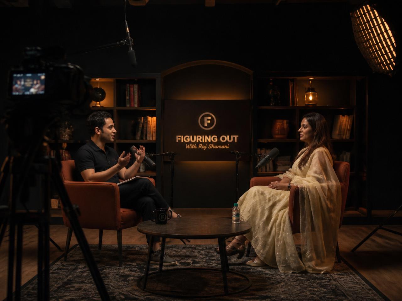 Indian video podcast studio with two people recording an interview on camera